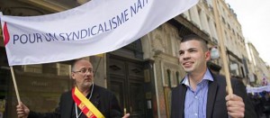 Thierry Gourlot, FN, and Fabien Engelmann, FN mayor of Hayange, holding a banner reading: 'For national syndicalism'