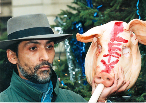 Lubo Zubak demonstrating at the Czech Prime Minister’s office on 10 December 1997, hold a pig's head with the word LETY written in lipstick