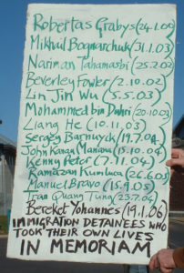 Placard detailing the names of those that have died in immigration detention