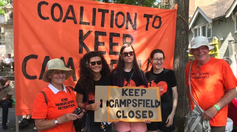 Image showing big banner saying COALITION TO KEEP CAMPSFIELD CLOSED with five activists holding a placard saying the same thing.