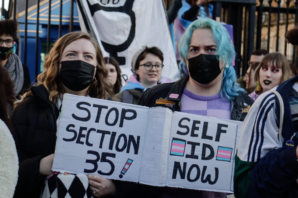 Two protesters outside Downing Street, 21 January holding up placards saying stop section 35, self id now.